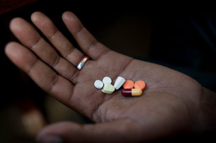 Handful of tablets on the palm of the hand. Concept for Registering Drugs